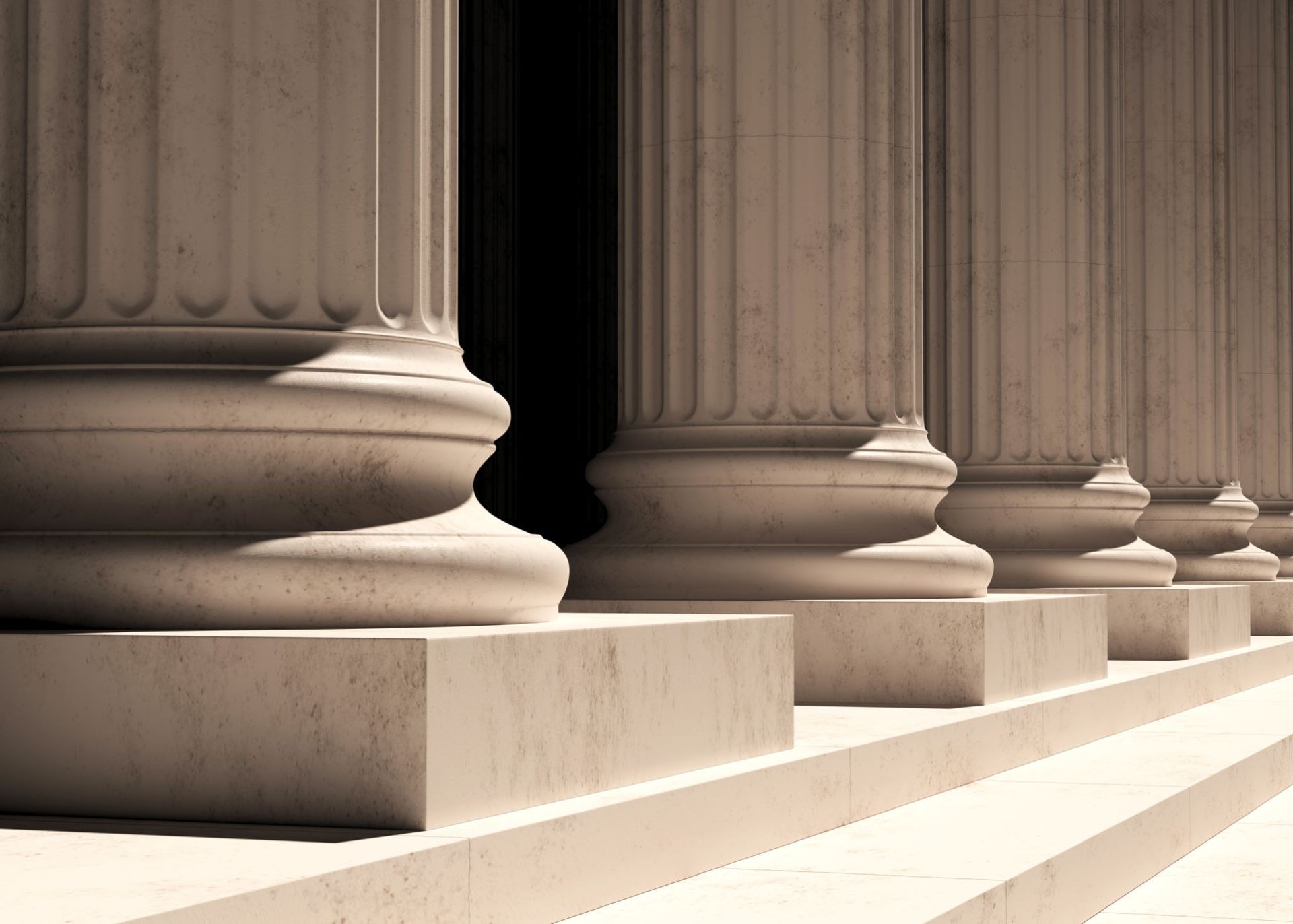 Close-up view of stone columns with detailed bases, part of a classical architectural structure.